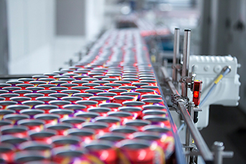 image of cans on a conveyer belt