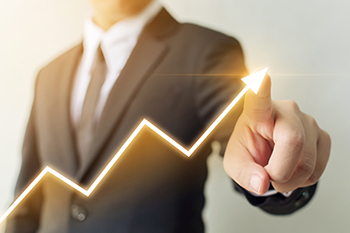 image of man indicating upward trend with arrow